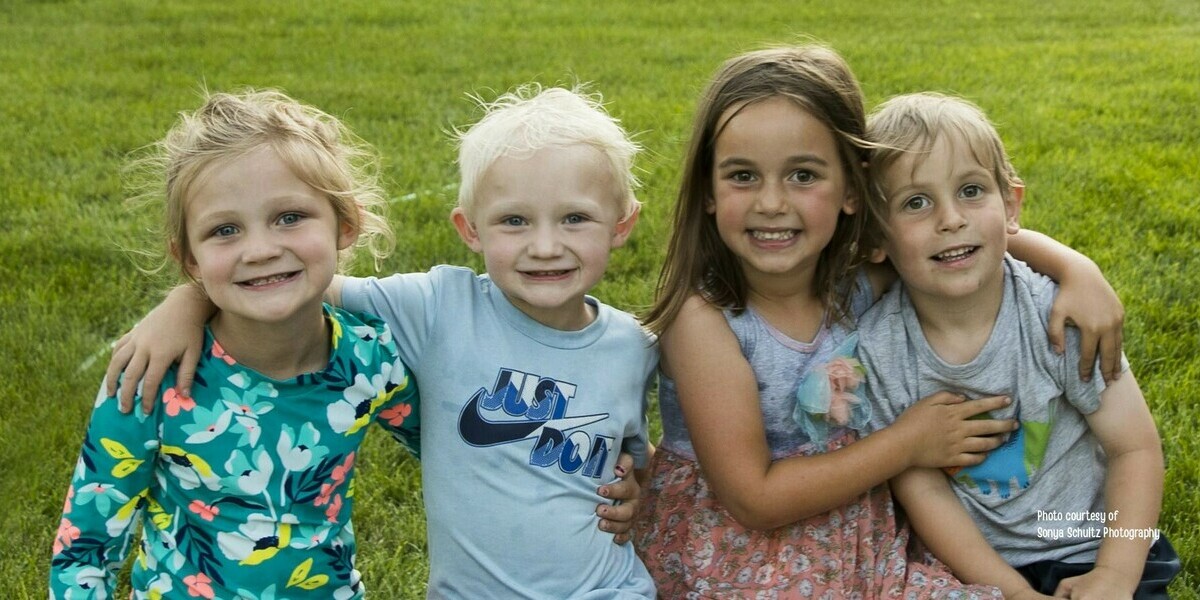 four kids on a bench